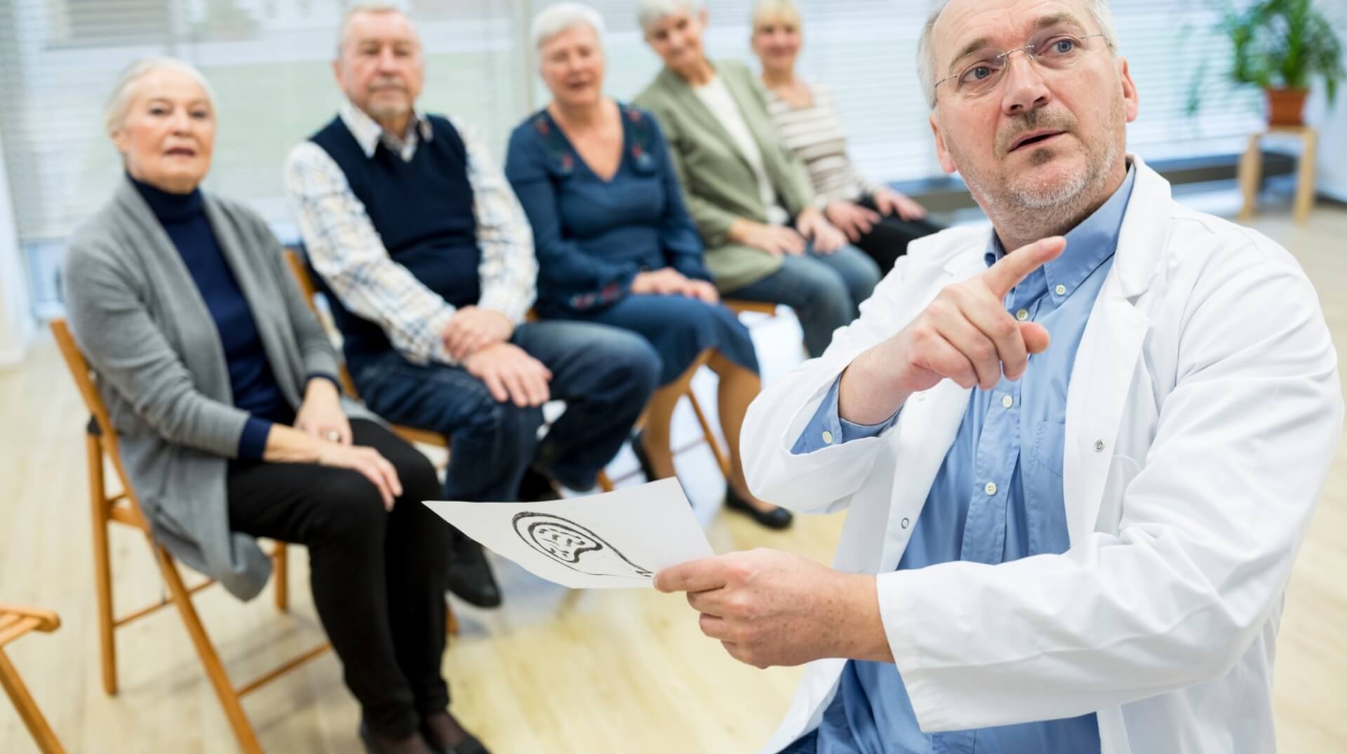 A doctor talking with a group of patients